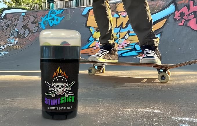 Stunt Stick Skateboard Wax positioned in a skate park, perfect for stylish grinds and smooth boardslides.